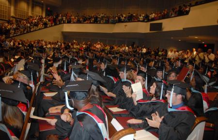 Friends and families give the graduates a standing ovation for their hard work at the end of the August graduation ceremony. - Photo by Morris Abernathy