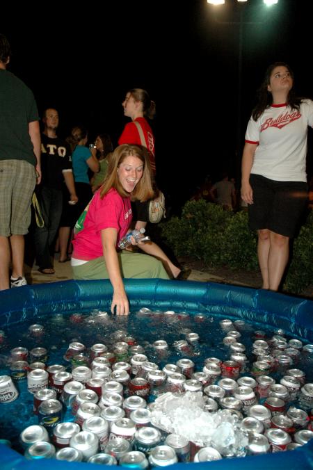 Senior Learning Foundations Major Carolyn Negley grabs a soda from the cooler at the Howdy Party. - Photo by Neisha Fuson