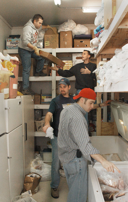 Union staff members team up to clean and organize the food pantry at The Care Center during Martin Luther King Jr. service day.  Pictured in the background are Mark VanderHaar (left) and Ben Mandrell and in the foreground are Bobby Ludwig (left) and Jay Ridenour.
 - Photo by Jim Veneman