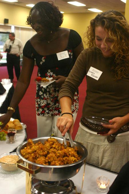 D.J. Sissiko and Brittany Burkett enjoy Chef Greg's cooking during the President's Reception in Coburn. - Photo by Stephanie Schroeder
