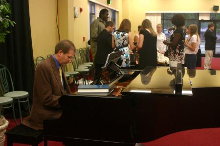 David Dennis provided background music as students, faculty and staff enjoyed refreshments at the President's Reception in Coburn. - Photo by Stephanie Schroeder