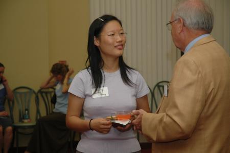 Jasmine Huang talks with Don Richard while enjoying some punch at the President's Reception. - Photo by Neisha Fuson
