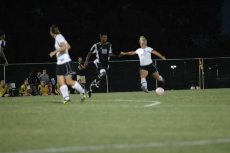 Junior Caitlin Zimmerman, pre-physical therapy major, passes the ball past the Belthel defender. - Photo by Matt Elia