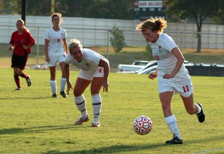 Brooke Walker dribbles down the field as teammates Caitlin Zimmerman and Korie Elrod follow behind. - Photo by Steven Aldridge