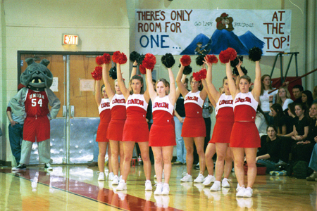 The Union University Cheerleaders wait with arms in the air during a free throw attempt. - Photo by Justin Veneman