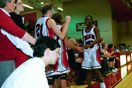 Junior Christal Merriweather (25) takes a breather as Head Coach Mark Campbell continues his watch on the action. - Photo by Jim Veneman