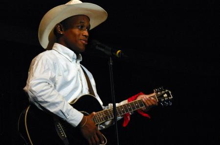 Sophomore Darrion Garrett poses as Josh Turner and sings acapella to a country song for his talent during Mr. Campus. - Photo by Stephanie Schroeder