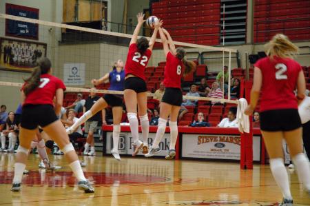 Juniors Brisa Berlin (22) and Emilie Ogas (6) spring up to block the ball against Trevecca Nazarene University.  - Photo by Neisha Fuson