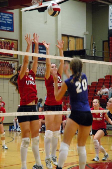 Juniors Emilie Ogas (left) and Brisa Berlin jump to block the volleyball from Trevecca Nazarene University's attack.  - Photo by Neisha Fuson