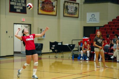 Junior Tiven Catrett serves the volleyball in a game against Mid-Continent University.  - Photo by Neisha Fuson