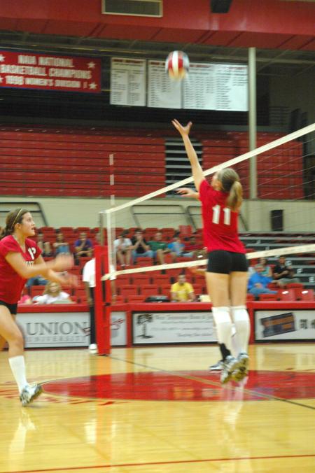 Junior Jennifer Martins sets the ball for Freshman Jill Dake in a game against Mid-Continent University. - Photo by Neisha Fuson