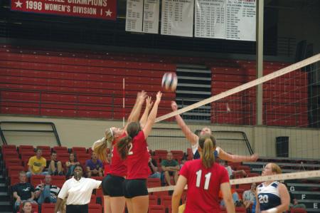 Junior CJ Neathamer and Freshman Jill Dake attempt a block against Mid-Continent University.  - Photo by Neisha Fuson