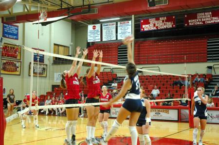 Freshman Jill Dake and Junior Jennifer Martins go up for a block against Mid-Continent University.  - Photo by Neisha Fuson