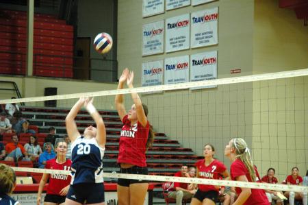Freshman Jill Dake goes up for a block against Mid-Continent University  - Photo by Neisha Fuson