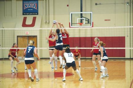 The Lady Bulldogs battle it out at the net against Mid-Continent University.  - Photo by Neisha Fuson