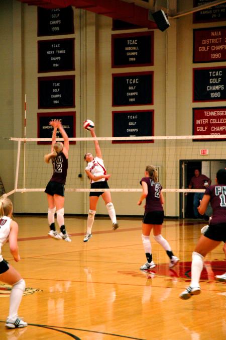 Junior Emilie Ogas spikes the ball past a Freed-Hardeman defender. - Photo by Matt Elia