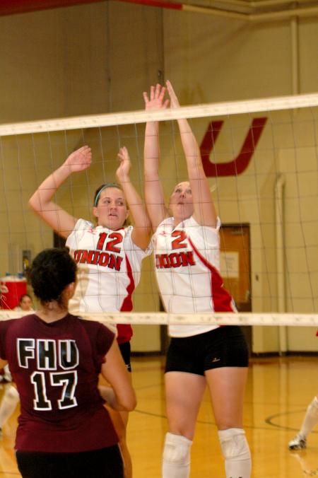 Freshman Jill Dake (left) and junior CJ Neathamer (right) go up for a attempted block in Union's match versus Freed-Hardeman. - Photo by Matt Elia