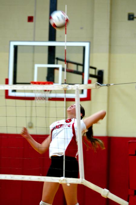 Junior Emilie Ogas goes up high for the kill. - Photo by Matt Elia