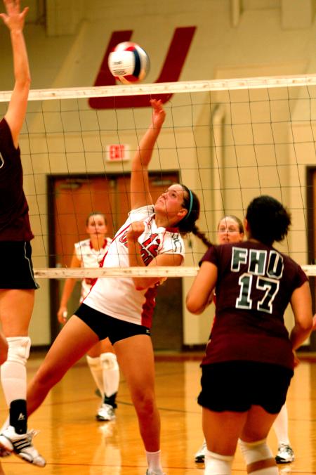 Freshman Jill Dake dinks the ball toward the FHU defenders. - Photo by Matt Elia