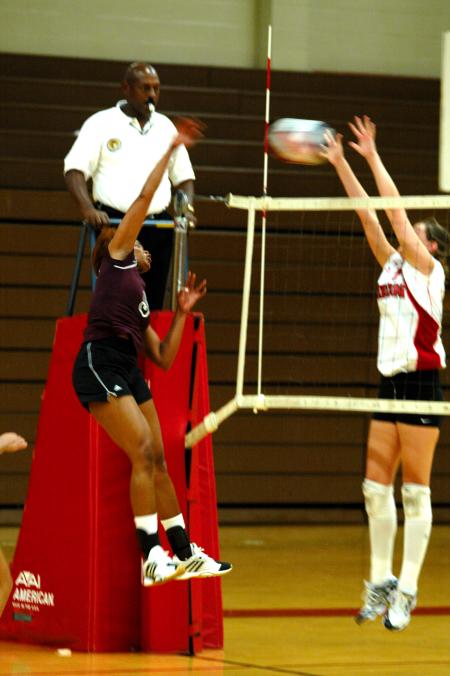 Junior Tiven Catrett blocks an attempted spike by FHU. - Photo by Matt Elia