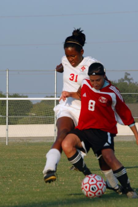 Freshman Eboni Murphy attempts to steal the ball from her Lyon College opponent.  - Photo by Neisha Fuson