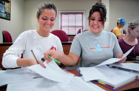 Freshmen Ashley Freeland and Cassie Badillo work together according to the newly implemented POGIL method to solve problems in Dr. Merkin’s chemistry class in White Hall. 
 - Photo by Matthew Diggs