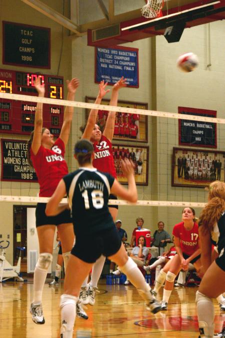 Juniors Emilie Ogas and Brisa Berlin block a hit by Lambuth University. - Photo by Stephanie Schroeder