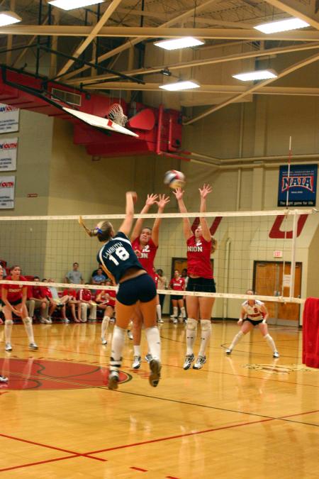 Junior CJ Neathamer and Freshman Jill Dake block a ball hit by a Lambuth player in Union's victory. - Photo by Stephanie Schroeder