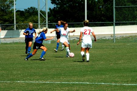 Sophomore Cara Pasley passes the ball forward to sophomore teammate Katelin Dirksen.
 - Photo by Matt Elia