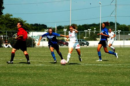 Sophomore Cara Pasley dribbles the ball upfield between two University of Alabama-Huntsville opponents. - Photo by Matt Elia