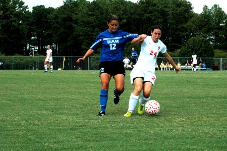 Sophomore Nikki Burau protects the ball from a defender. - Photo by Matt Elia