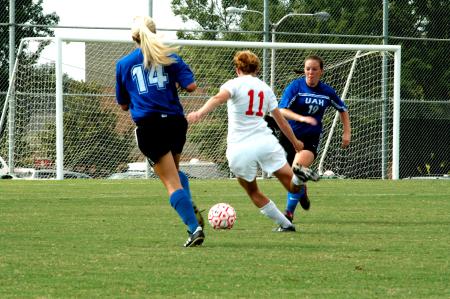 Sophomore Brooke Walker dribbles past two defenders before an attempted shot on goal. - Photo by Matt Elia
