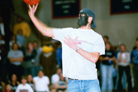 Matthew “Grant” Cooper tries his hand at the $10,000 Halfcourt shot during halftime of the Homecoming 2003 basketball game. - Photo by Justin Veneman