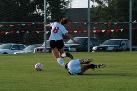 Lady Bulldog sophomore Roxanna Skelton lunges for the ball and nearly trips over the already fallen opponent from Lambuth University.  - Photo by Neisha Fuson