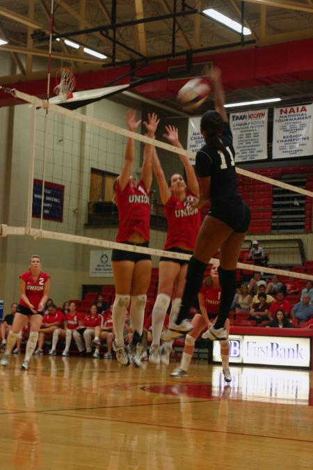 Juniors Jennifer Martins and Brisa Berlin block a hit by Martin Methodist College (Tenn.). - Photo by Stephanie Schroeder