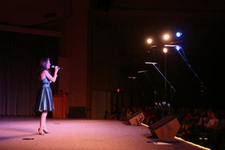 Victoria Green, emcee to All-Sing during Family Weekend, performs a solo number. - Photo by Stephanie Schroeder