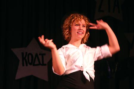 Emma Robertson performs one of many numbers done by Cody Curtis's large group for All-Sing during Family Weekend. - Photo by Stephanie Schroeder