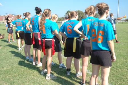 An independent flag football team prepares to take the field during Family Weekend. - Photo by Neisha Fuson