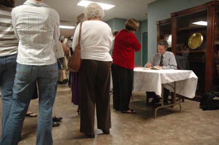 Dr. Edward L. Ayers signed books and spoke with members of the audience at the Carls-Schwerdfeger History Lecture Series.  - Photo by Neisha Fuson