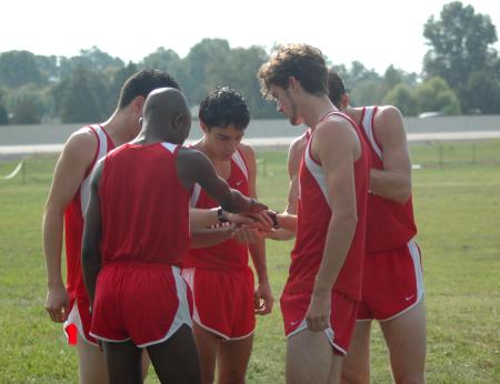 The Union men's cross country team prays before they compete in the Union Invitational. - Photo by Tommy Sadler