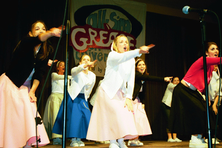 Chi Omega performs a number from <i>Grease</i> at All-Sing during Homecoming 2003. - Photo by Lindsay Stavish