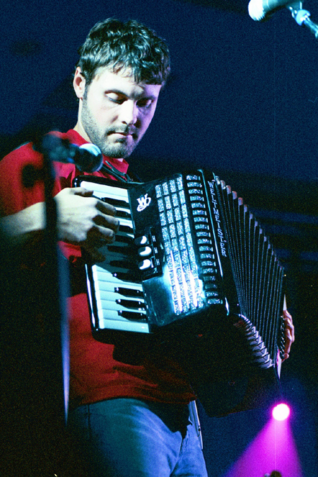 Gabe Scott assisted Bebo by playing a variety of unusual instruments such as this accordian. - Photo by Lindsay Stavish