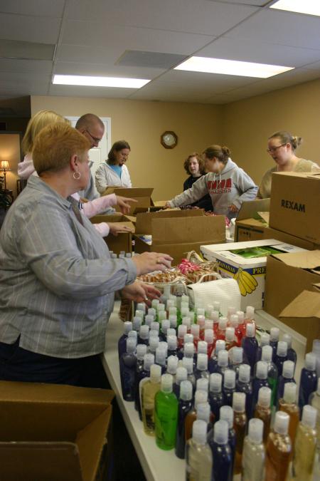 Phyllis Davenport, Nurse Paul Mayer, and students sort through boxes of bath goods to be repackaged into gift bags for mothers at Birth Choice during Day of Remembrance. - Photo by Stephanie Schroeder