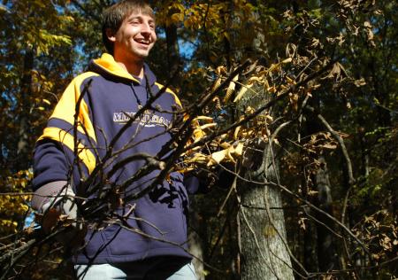Senior Cameron Armstrong, history major, helps clear away the grounds at Fort Pillow State Historic Park on Day of Remembrance. - Photo by Matthew Diggs