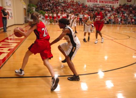 Union sophomore Lindsay Flynn drives around defenders during the Homecoming victory over Harris-Stowe State College (Mo.).
 - Photo by Neisha Fuson