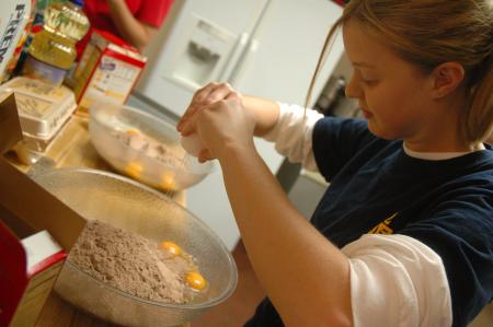 Sophomore Tracey Blackwell mixes up some cake batter for a banquet put on by J-Crib Ministries during Day of Remembrance. - Photo by Neisha Fuson