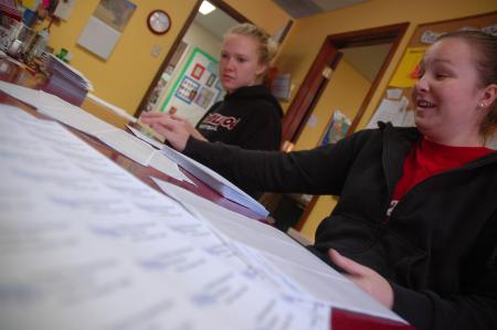 Chelsea Crook and Ella Joines of the Lady Bulldog basketball team helps J-Crib ministries on Day of Remembrance by addressing and stuffing some envelopes to be used to gain support for the ministry.  - Photo by Neisha Fuson