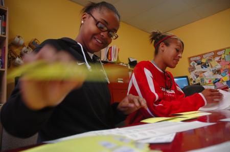 Freshman Latoya Bellamy, who plays on the lady bulldog basketball team, and Stephanie Clark, lady bulldog assistant coach, volunteer their time with J-Crib Ministries during Day of Remembrance.  - Photo by Neisha Fuson