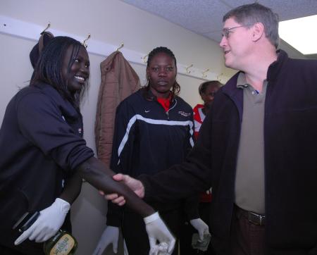 Jim Suddath, senior pastor at Evangelical Community Church in Jackson, shakes Freshman Zeinab Chan's arm, since she has a cleaning glove on her hand, while cleaning for J-Crib Ministry on Day of Remembrance.  - Photo by Neisha Fuson