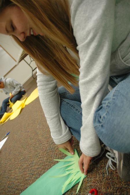 Sophomore Molly Burns cuts out a cactus during Day of Remembrance for J-Crib Ministry's banquet.  - Photo by Neisha Fuson